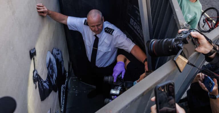 New Banksy mural hidden by guards at London’s Royal Courts of Justice