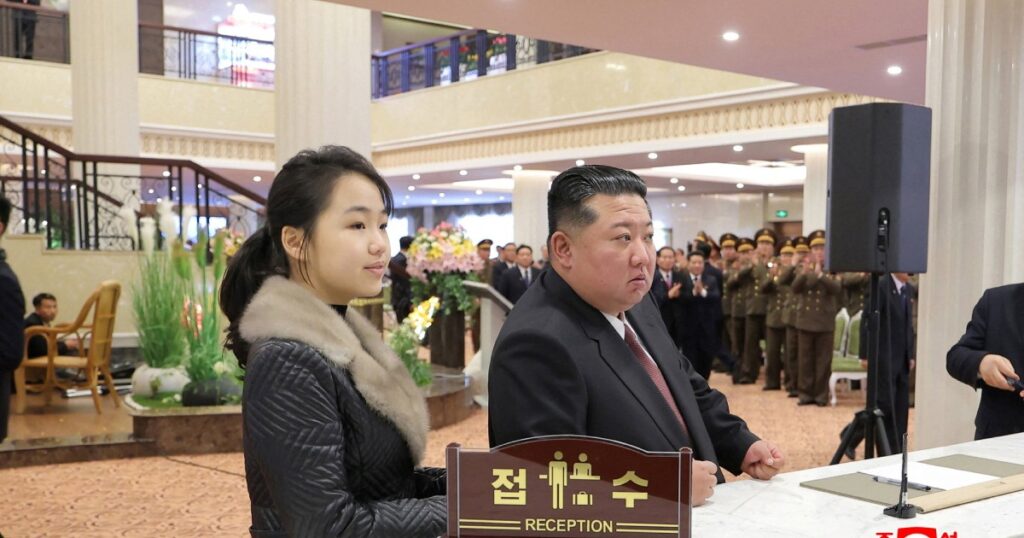 North Korean leader Kim Jong-un and his daughter Kim Ju Ae stand at a hotel reception counter as they attend an inauguration ceremony for hotels in the tourist resort in Samjiyon City, North Korea, Dec 20, 2025, in this picture released by North Korea's official Korean Central News Agency.