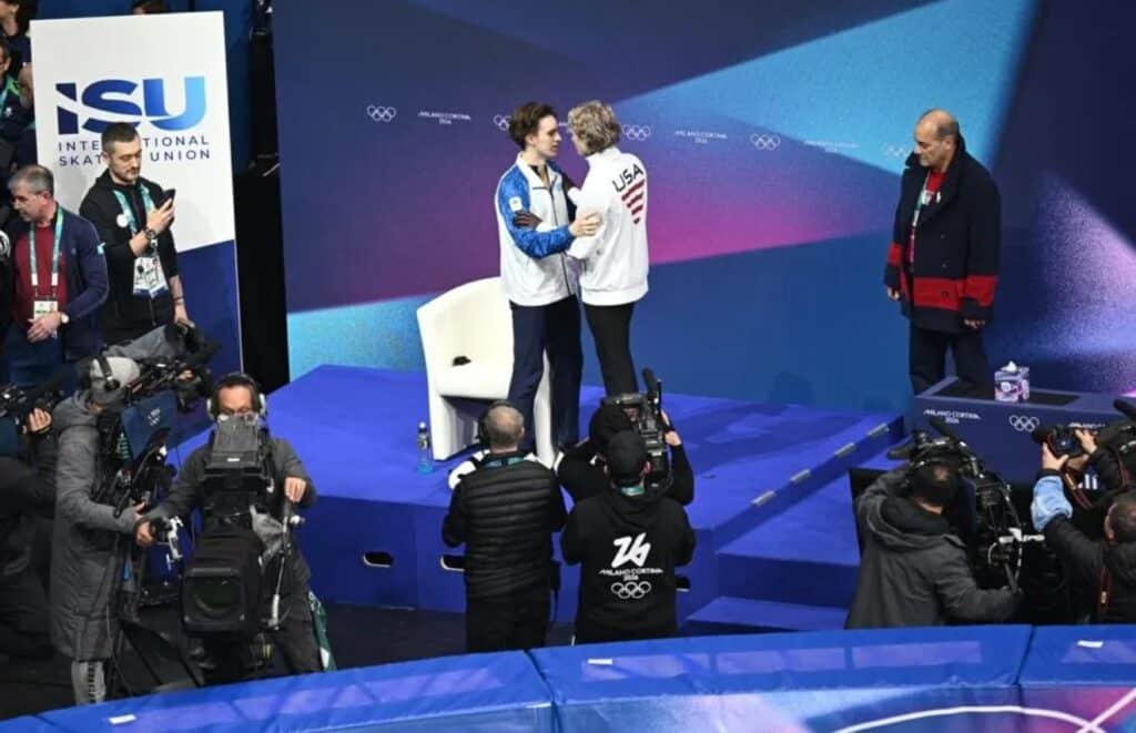 USA's Ilia Malinin (CR) speaks with gold medallist Kazakhstan's Mikhail Shaidorov (CL) after competing in the figure skating men's singles free skating final during the Milano Cortina 2026 Winter Olympic Games at Milano Ice Skating Arena in Milan on February 13, 2026. 