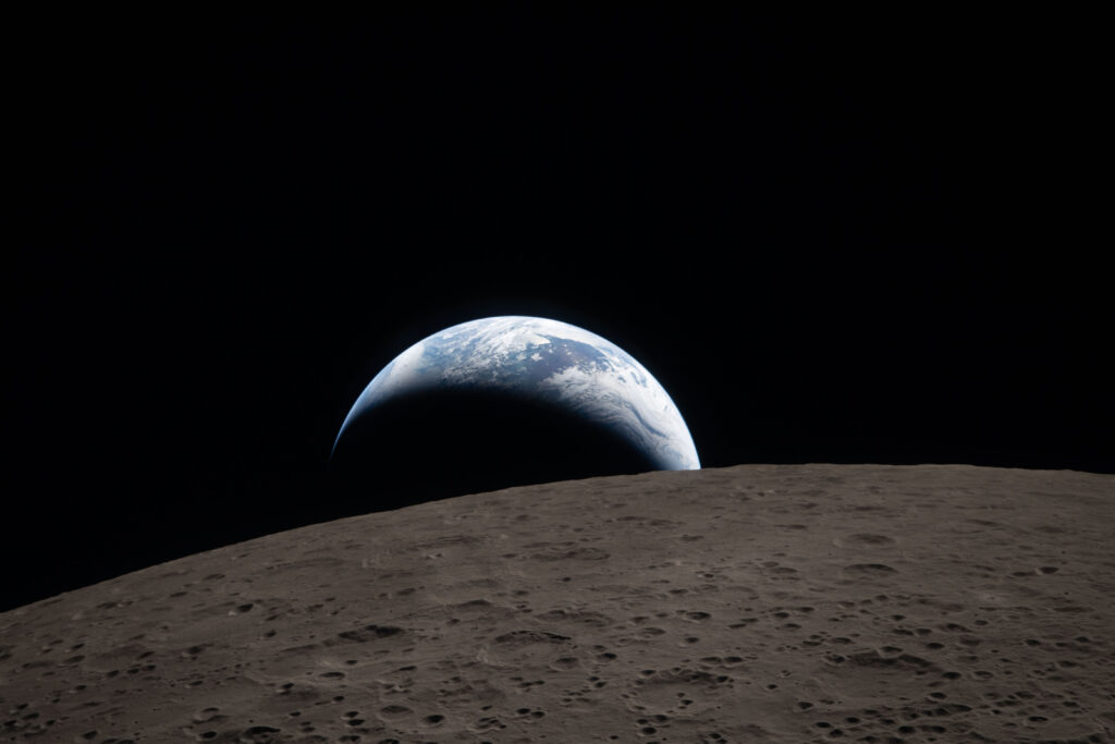 art002e009288 (April 6, 2026) – Earthset captured through the Orion spacecraft window at 6:41 p.m. EDT, April 6, 2026, during the Artemis II crew’s flyby of the Moon. A muted blue Earth with bright white clouds sets behind the cratered lunar surface.
The dark portion of Earth is experiencing nighttime. On Earth’s day side, swirling clouds are visible over the Australia and Oceania region.  
In the foreground, Ohm crater has terraced edges and a flat floor interrupted by central peaks. Central peaks form in complex craters when the lunar surface, liquefied on impact, splashes upwards during the crater’s formation.