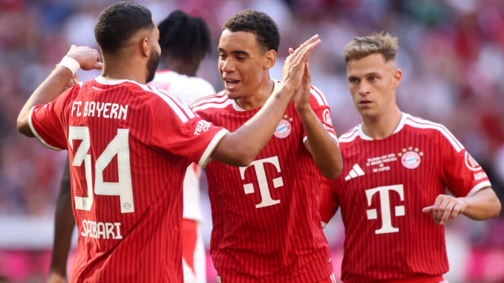 MUNICH, GERMANY - AUGUST 15: Jamal Musiala of Bayern Munich celebrates scoring his team’s third goal with teammate Ismael Saibari during the Telekom Cup match between FC Bayern München and RB Leipzig at Allianz Arena on August 15, 2026 in Munich, Germany. (Photo by Alex Grimm/Getty Images)